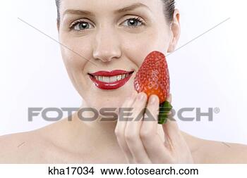Stock Photo - close up of woman 
about to eat strawberry. 
fotosearch - search 
stock photos, 
pictures, images, 
and photo clipart