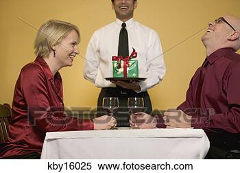 Stock Image - couple enjoying 
dinner at restaurant. 
fotosearch - search 
stock photos, 
pictures, images, 
and photo clipart
