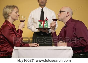Picture - couple enjoying 
wine at restaurant. 
fotosearch - search 
stock photos, 
pictures, images, 
and photo clipart