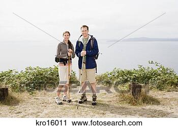 Stock Photography - couple holding 
hiking poles. 
fotosearch - search 
stock photos, 
pictures, images, 
and photo clipart