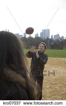 Picture - couple playing 
catch in park 
with view of city 
skyline. fotosearch 
- search stock 
photos, pictures, 
images, and photo 
clipart