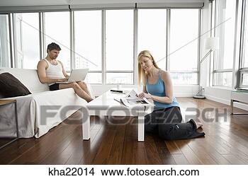 Stock Photo - couple relaxing 
in living room. 
fotosearch - search 
stock photos, 
pictures, images, 
and photo clipart