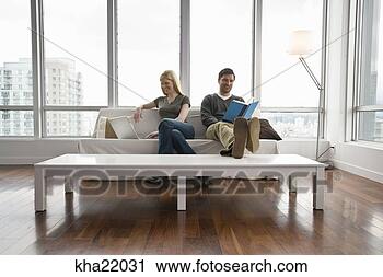 Stock Photography - couple relaxing 
in living room. 
fotosearch - search 
stock photos, 
pictures, images, 
and photo clipart