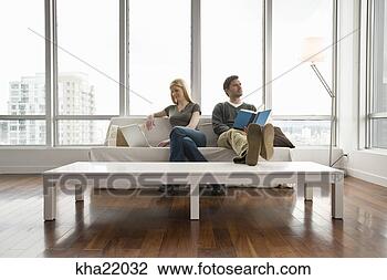 Stock Photo - couple relaxing 
in living room. 
fotosearch - search 
stock photos, 
pictures, images, 
and photo clipart