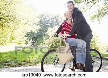 Stock Photography - couple riding 
same bicycle. 
fotosearch - search 
stock photos, 
pictures, images, 
and photo clipart