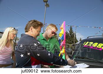 Stock Photo - couple signing 
contracts to buy 
used car. fotosearch 
- search stock 
photos, pictures, 
images, and photo 
clipart