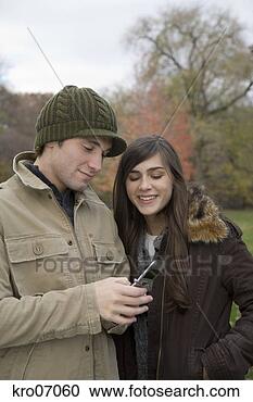 Stock Photography - couple using a 
cell phone. fotosearch 
- search stock 
photos, pictures, 
images, and photo 
clipart