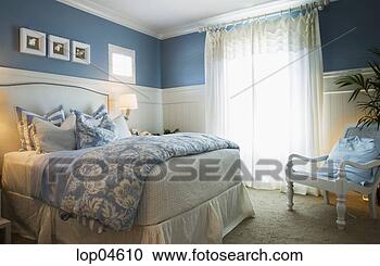 Stock Photography - cozy blue bedroom 
with flower linens. 
fotosearch - search 
stock photos, 
pictures, images, 
and photo clipart