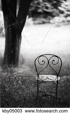 Stock Photo - empty wire chair 
in backyard. fotosearch 
- search stock 
photos, pictures, 
images, and photo 
clipart