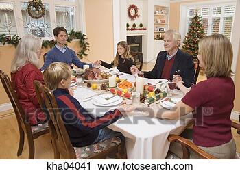 Stock Photography - family saying 
grace before christmas 
dinner. fotosearch 
- search stock 
photos, pictures, 
images, and photo 
clipart