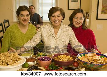 Picture - family starting 
dinner. fotosearch 
- search stock 
photos, pictures, 
images, and photo 
clipart