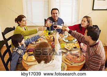 Stock Photograph - family toasting 
each other at 
dinner table. 
fotosearch - search 
stock photos, 
pictures, images, 
and photo clipart