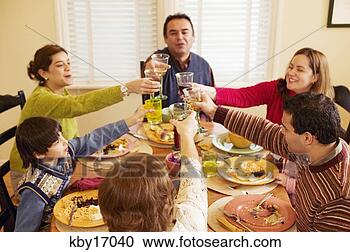 Stock Photography - family toasting 
each other at 
dinner table. 
fotosearch - search 
stock photos, 
pictures, images, 
and photo clipart