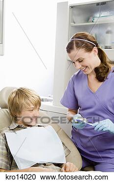 Stock Photography - female dentist 
showing patient 
how to brush. 
fotosearch - search 
stock photos, 
pictures, images, 
and photo clipart