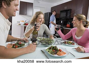 Stock Photo - friends eating 
together. fotosearch 
- search stock 
photos, pictures, 
images, and photo 
clipart