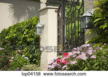 Stock Photo - front gate of 
home surrounded 
by garden. fotosearch 
- search stock 
photos, pictures, 
images, and photo 
clipart