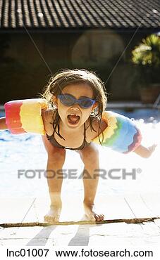 Picture - girl wearing water 
wings next to 
swimming pool. 
fotosearch - search 
stock photos, 
pictures, images, 
and photo clipart