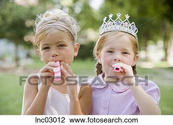 Stock Photo - girls blowing 
noise makers. 
fotosearch - search 
stock photos, 
pictures, images, 
and photo clipart