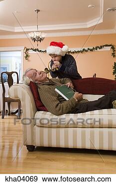 Stock Photograph - grandson blowing 
horn in sleeping 
grandfather’s 
ear. fotosearch 
- search stock 
photos, pictures, 
images, and photo 
clipart