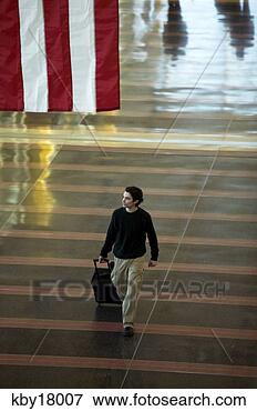Picture - high angle view 
of man walking 
through airport, 
 reagan international. 
fotosearch - search 
stock photos, 
pictures, images, 
and photo clipart