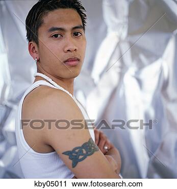 Stock Photography - hispanic man showing 
off tattoo. fotosearch 
- search stock 
photos, pictures, 
images, and photo 
clipart