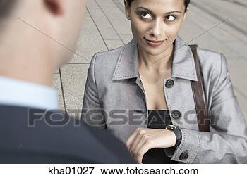 Picture - indian businesswoman 
checking her watch. 
fotosearch - search 
stock photos, 
pictures, images, 
and photo clipart