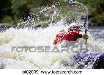 Stock Photograph - kayaker paddling 
through white 
water. fotosearch 
- search stock 
photos, pictures, 
images, and photo 
clipart