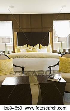 Stock Photograph - large cozy bed 
and seating area. 
fotosearch - search 
stock photos, 
pictures, images, 
and photo clipart