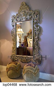 Stock Photo - large ornate mirror 
on purple bedroom 
wall. fotosearch 
- search stock 
photos, pictures, 
images, and photo 
clipart