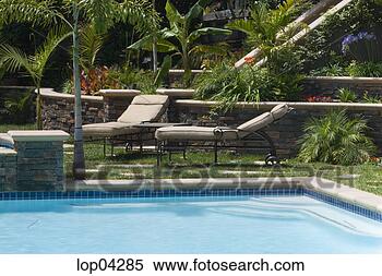 Stock Image - lawn chairs next 
to swimming pool. 
fotosearch - search 
stock photos, 
pictures, images, 
and photo clipart