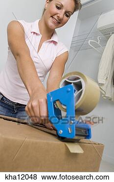 Stock Photo - low angle view 
of woman packing 
boxes. fotosearch 
- search stock 
photos, pictures, 
images, and photo 
clipart
