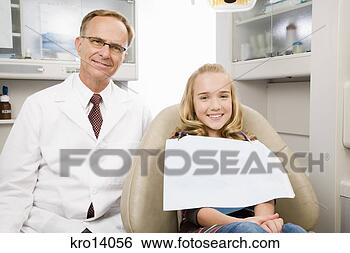 Stock Photo - male dentist and 
girl in dentist’s 
office. fotosearch 
- search stock 
photos, pictures, 
images, and photo 
clipart