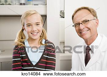 Stock Photo - male dentist and 
girl in dentist’s 
office. fotosearch 
- search stock 
photos, pictures, 
images, and photo 
clipart