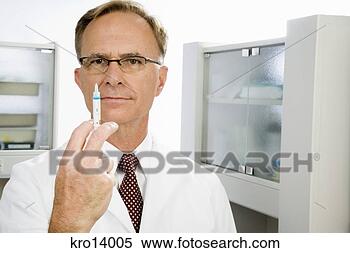 Stock Image - male doctor holding 
syringe. fotosearch 
- search stock 
photos, pictures, 
images, and photo 
clipart