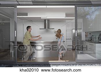 Stock Photography - man chasing woman 
in kitchen. fotosearch 
- search stock 
photos, pictures, 
images, and photo 
clipart