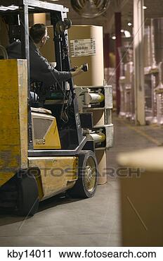 Stock Photography - man driving forklift 
in warehouse. 
fotosearch - search 
stock photos, 
pictures, images, 
and photo clipart