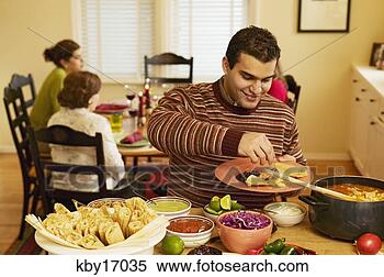Stock Image - man filling dinner 
plate. fotosearch 
- search stock 
photos, pictures, 
images, and photo 
clipart