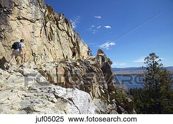 Stock Image - man hiking on 
rocky mountain, 
grand tetons, 
wyoming, united 
states. fotosearch 
- search stock 
photos, pictures, 
images, and photo 
clipart