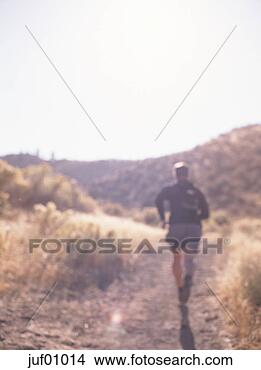 Stock Photo - man jogging down 
dirt path. fotosearch 
- search stock 
photos, pictures, 
images, and photo 
clipart