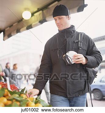 Stock Photo - man listening 
to cd player as 
he shops. fotosearch 
- search stock 
photos, pictures, 
images, and photo 
clipart
