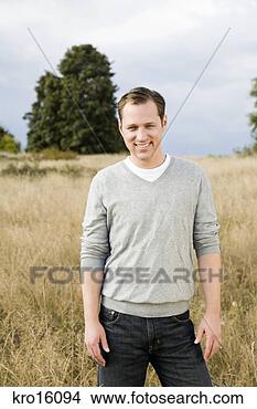 Stock Photo - man standing in 
field. fotosearch 
- search stock 
photos, pictures, 
images, and photo 
clipart