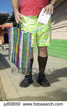 Stock Photography - man in tourist 
attire holding 
bag. fotosearch 
- search stock 
photos, pictures, 
images, and photo 
clipart
