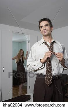 Stock Photo - man tying his 
tie. fotosearch 
- search stock 
photos, pictures, 
images, and photo 
clipart
