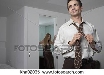 Stock Image - man tying his 
tie. fotosearch 
- search stock 
photos, pictures, 
images, and photo 
clipart