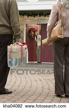Stock Photo - man and woman 
arriving with 
christmas presents. 
fotosearch - search 
stock photos, 
pictures, images, 
and photo clipart