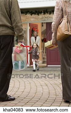 Stock Photo - man and woman 
arriving with 
christmas presents. 
fotosearch - search 
stock photos, 
pictures, images, 
and photo clipart