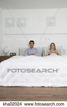 Stock Photo - man and woman 
sitting in bed. 
fotosearch - search 
stock photos, 
pictures, images, 
and photo clipart