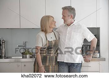 Stock Photo - middle-aged couple 
hugging. fotosearch 
- search stock 
photos, pictures, 
images, and photo 
clipart