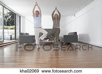 Stock Photograph - middle-aged couple 
practicing yoga. 
fotosearch - search 
stock photos, 
pictures, images, 
and photo clipart