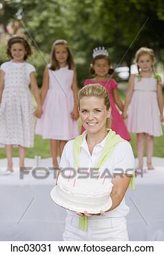 Stock Photography - mother holding 
daughter’s birthday 
cake. fotosearch 
- search stock 
photos, pictures, 
images, and photo 
clipart